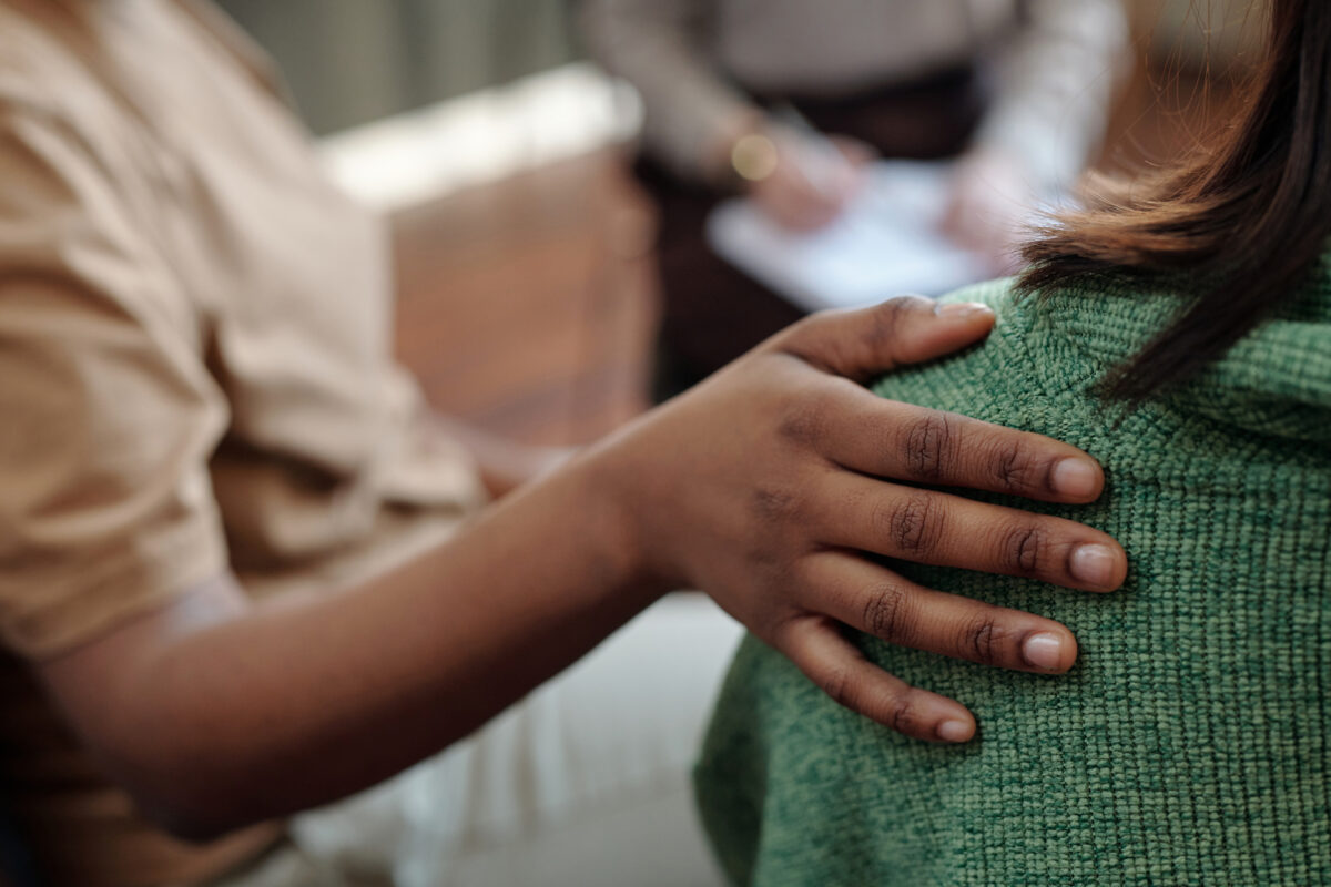 Hand of woman on back of her friend 2025 03 16 09 13 15 utc